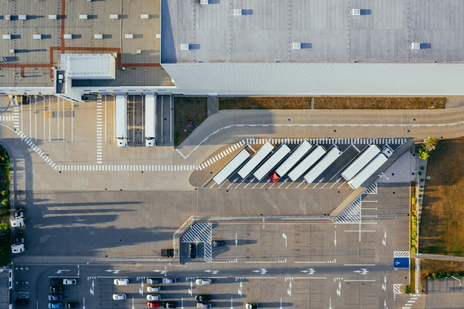 Aerial view of a distribution centre with loading bays and parked trailers